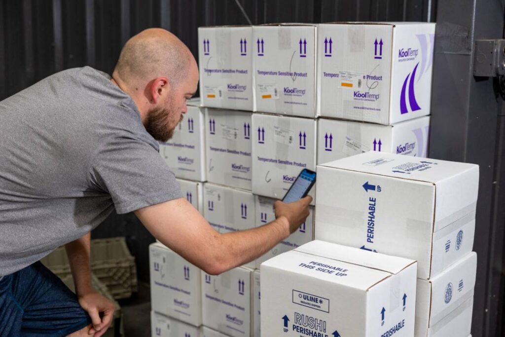 MedRx Logistics Team Member Scanning Boxes at Part of the 5 Points of Scan